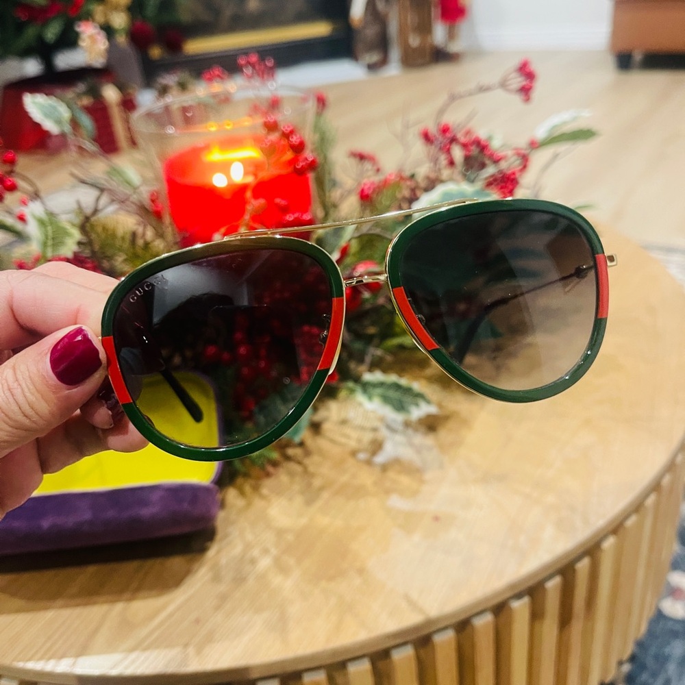 Gucci Unisex  Sunglasses with Green and gold frame.